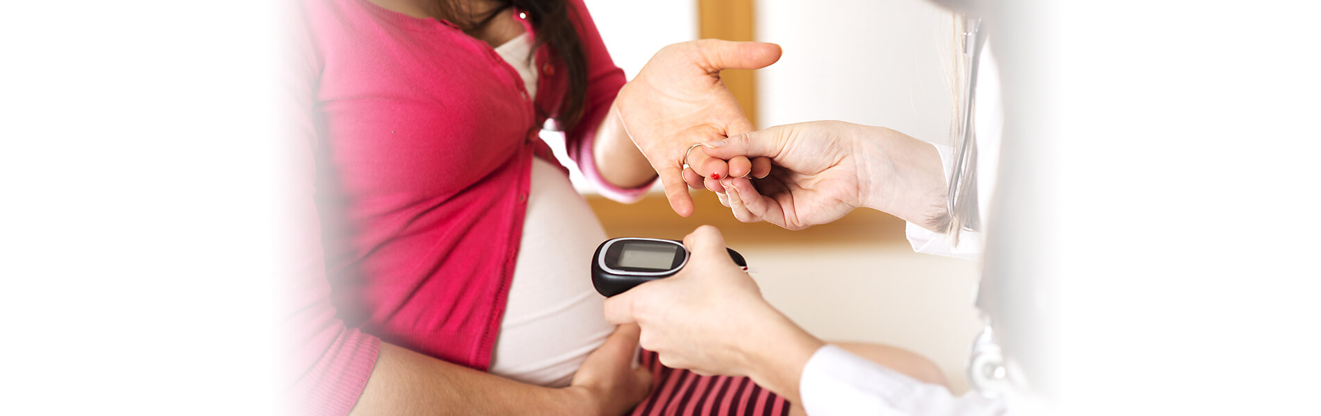 Image of pregnant woman having finger prick test to check blood glucose level