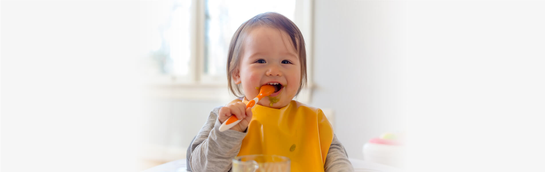 Happy toddler eating a meal